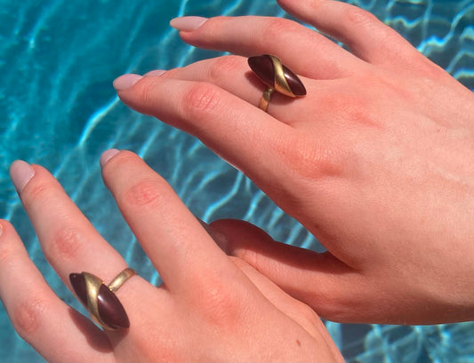 Two 1970s vintage gold tone and burgundy rings