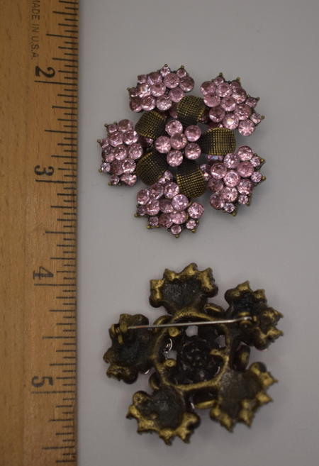 Two vintage reproduction pink rhinestone and brass brooches