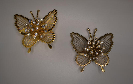 Two 1980's vintage gold tone butterfly brooches with rhinestone center