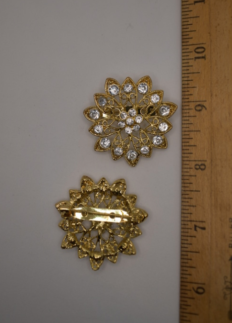 Two vintage reproduction gold tone and clear rhinestone brooches