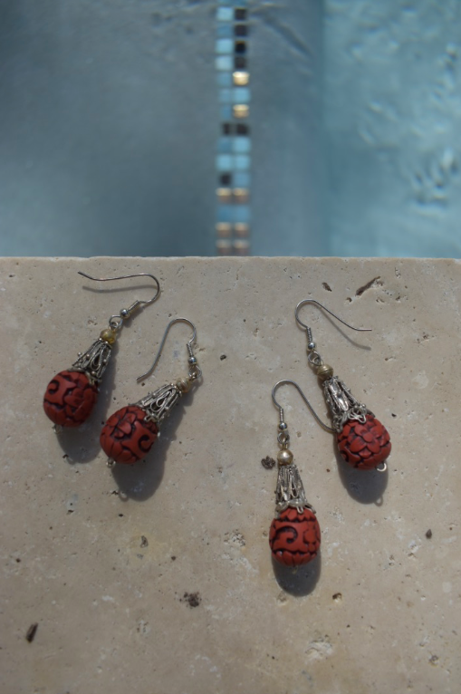 Two pairs of vintage bohemian style silver tone and red cinnabar dangle earrings