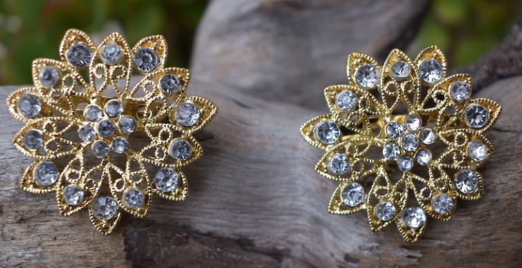 Two vintage reproduction gold tone and clear rhinestone brooches