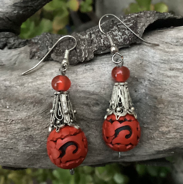 One pair of vintage bohemian style silver tone and red cinnabar dangle earrings